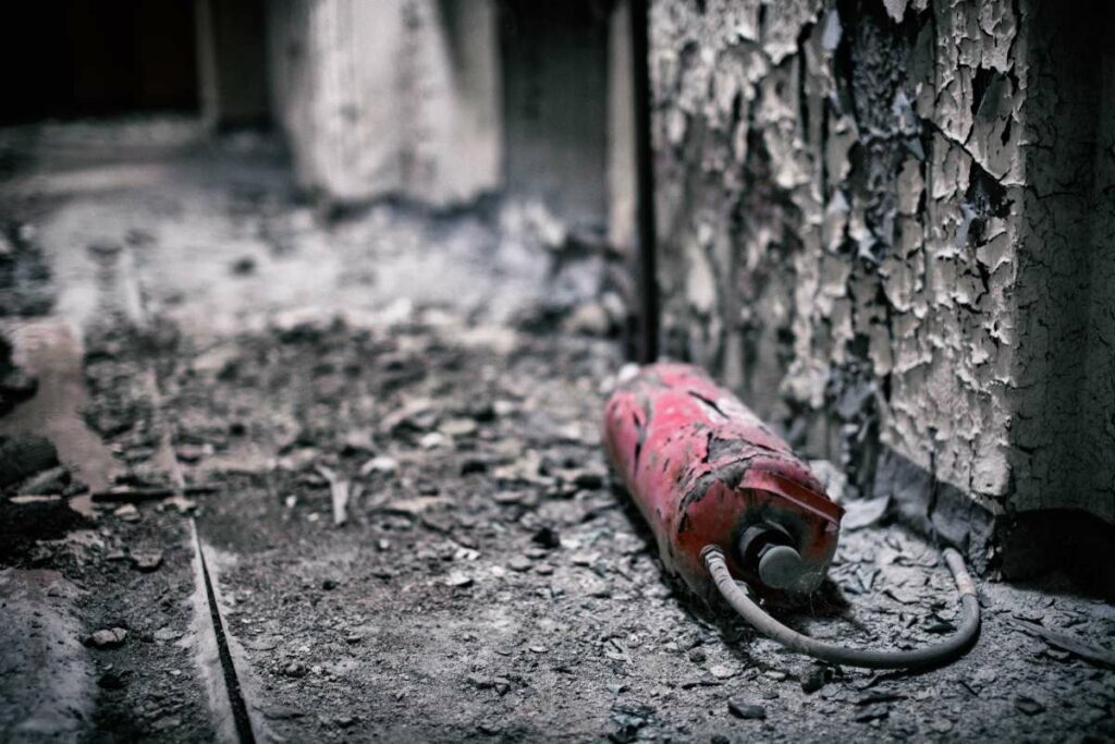 Empty fire extinguisher ready for disposal