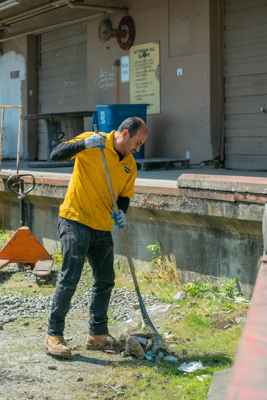 Seattle Yard Removal services Junk B Gone Employee Raking Lot Cleaning Up