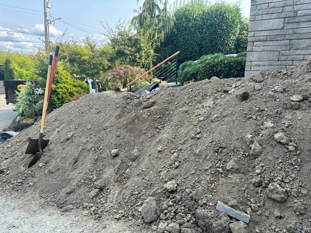 Large pile of dirt in a Seattle driveway ready for removal