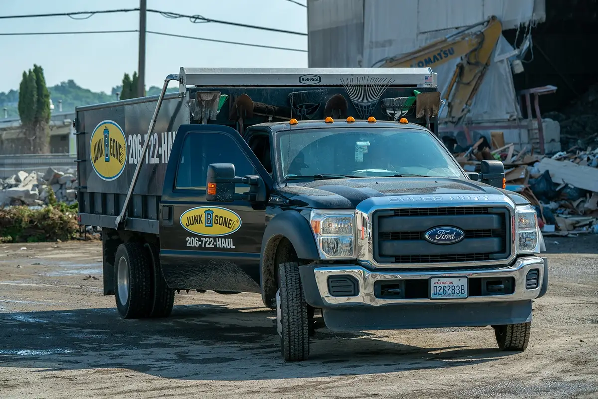 Junk B Gone truck at a King County recycling center with rear doors open