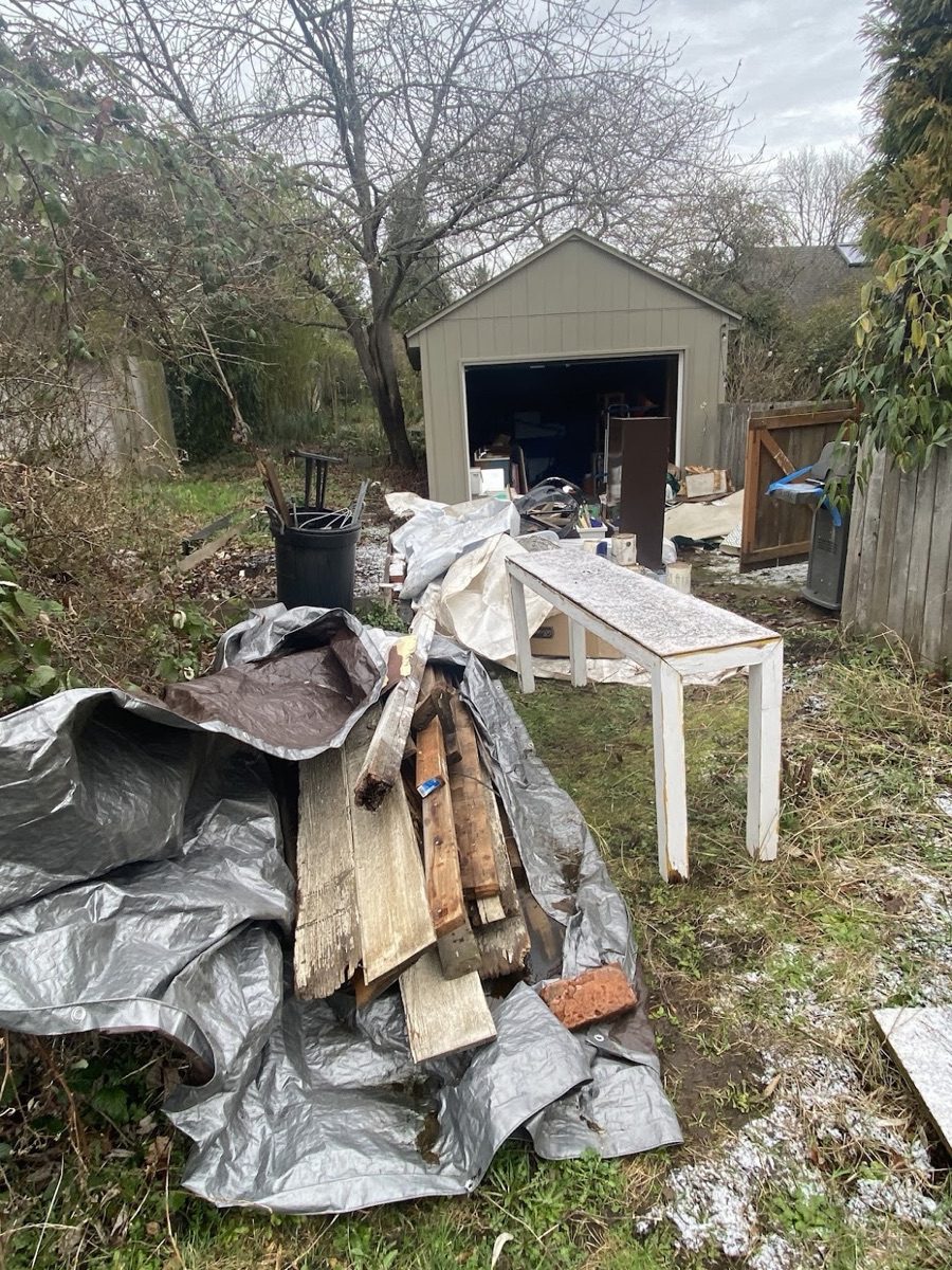 Before — Backyard cluttered with debris