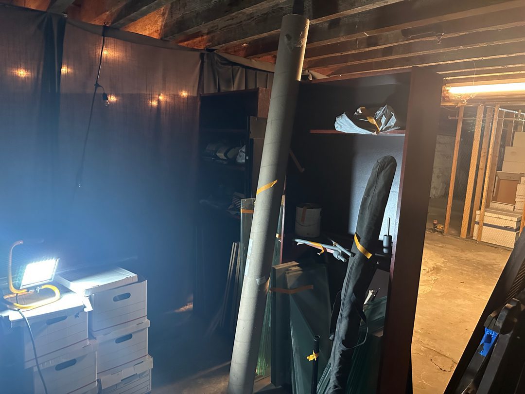 Cluttered underground storage area at Beneath the Streets in Pioneer Square before Junk B Gone removal