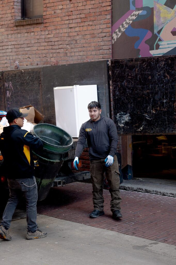 Junk B Gone crew loading mini-fridge — Seattle appliance removal