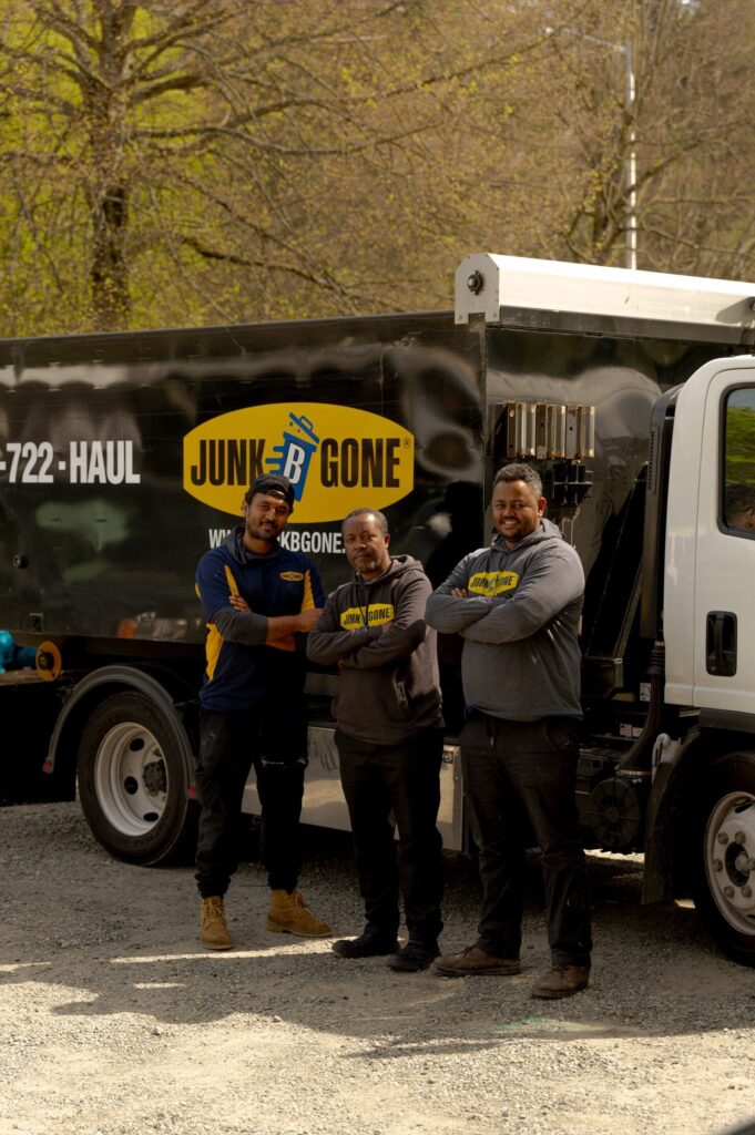 Junk B Gone Seattle crew standing in front of branded truck at company yard — same-day junk removal since 1989