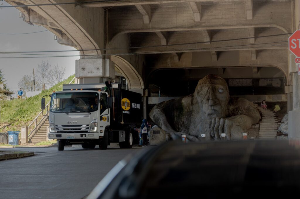 Junk B Gone truck at the Fremont Troll under the Aurora Bridge — Fremont junk removal