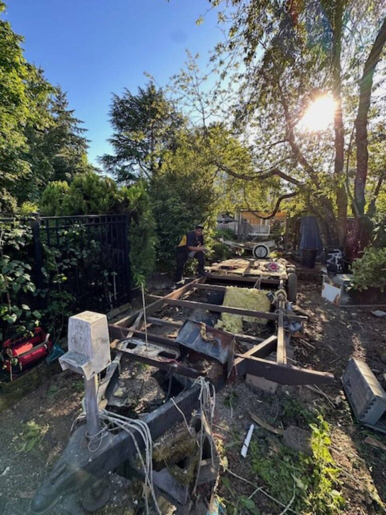Junk B Gone crew member working on RV frame during removal