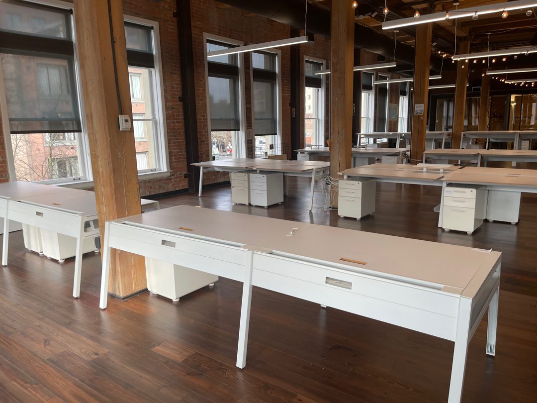 Big open Seattle loft office full of white workstation desks and file pedestals - a full floor of office furniture Junk B Gone hauls out in one visit