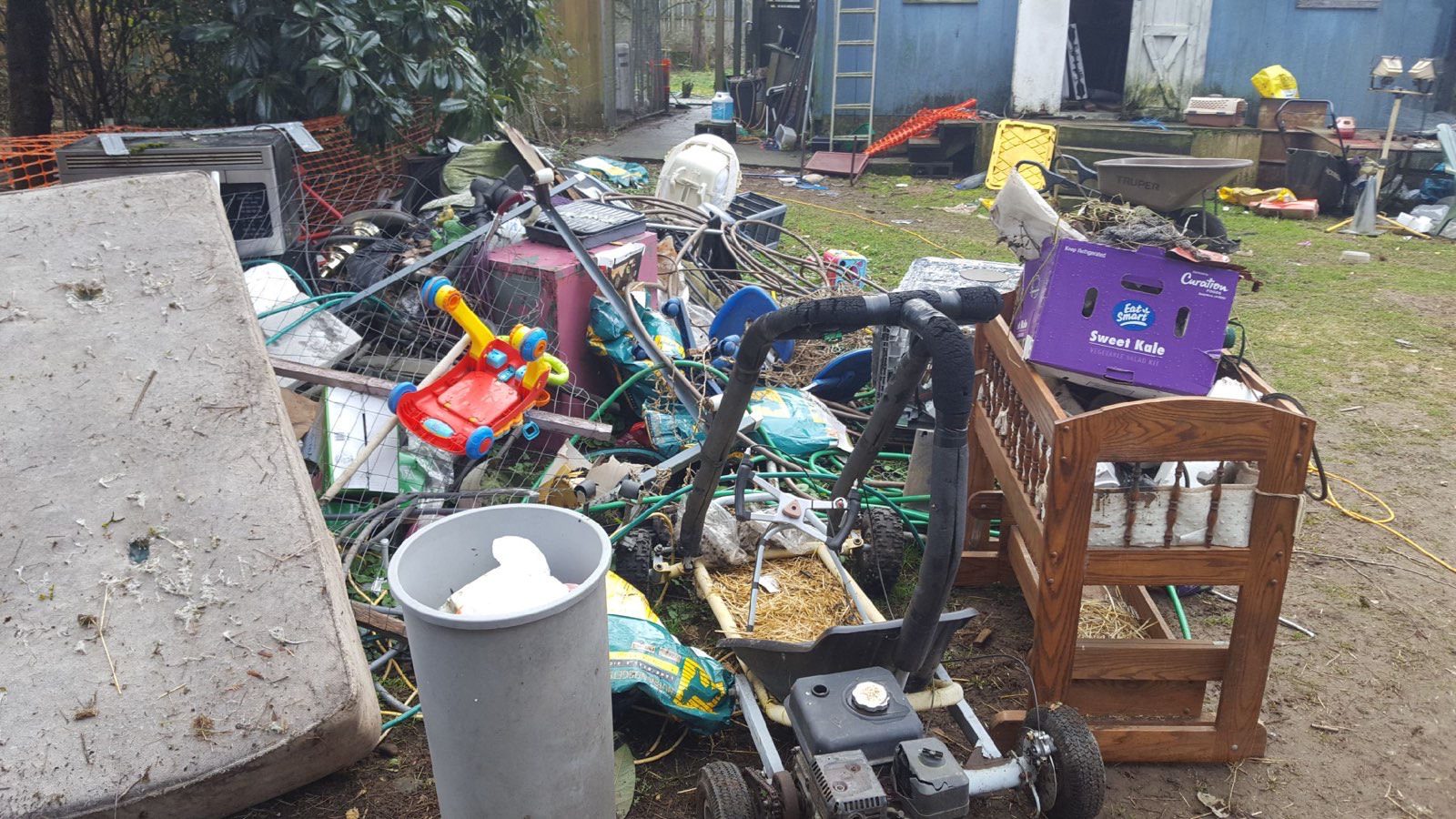 Seattle backyard piled with debris before Junk B Gone hauling