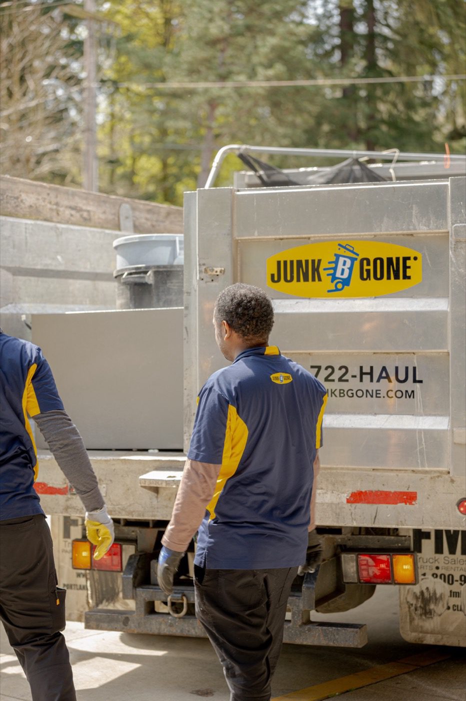 Listing cleanout in Seattle - Junk B Gone crew loading the branded truck in a driveway