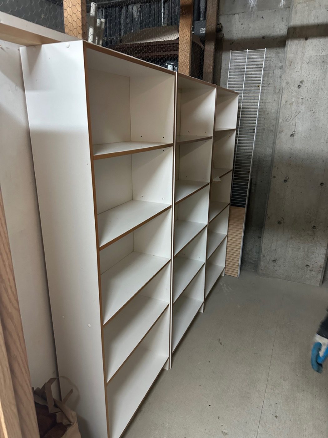 Storage shelving units emptied and left bare after a Junk B Gone clear-out in Seattle