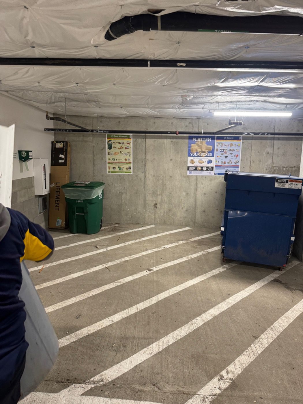 An apartment parking-garage storage bay cleared to clean concrete by Junk B Gone in Seattle