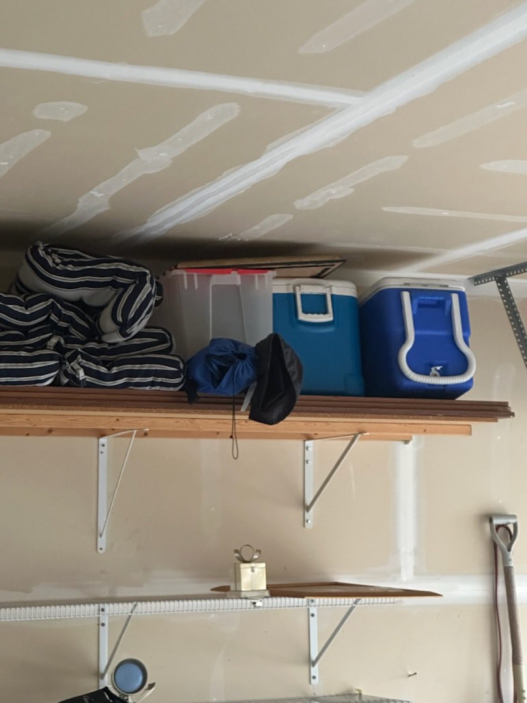 A garage overhead storage shelf tidied and reclaimed by the Junk B Gone crew in Seattle