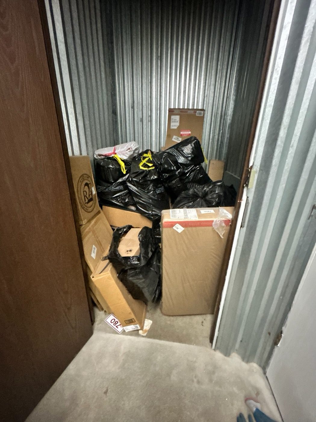 A self-storage locker packed with boxes and bags before a Junk B Gone clear-out in Seattle