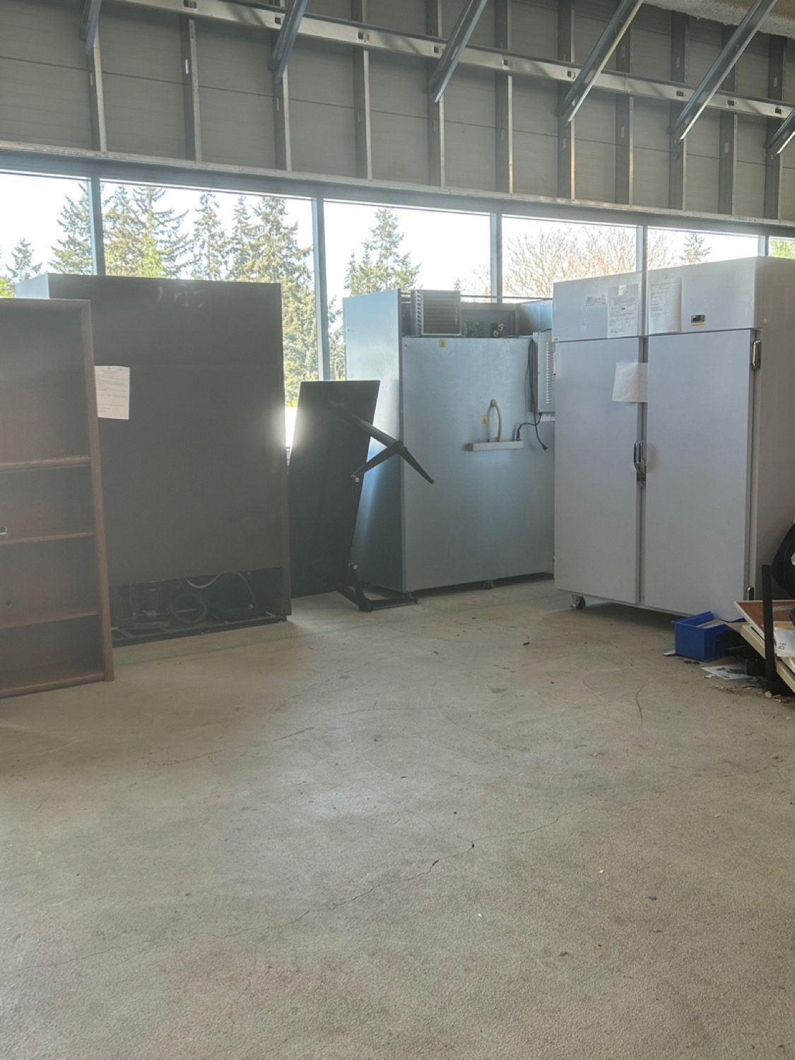 A warehouse storage space cleared to an open floor after junk removal by Junk B Gone in Seattle