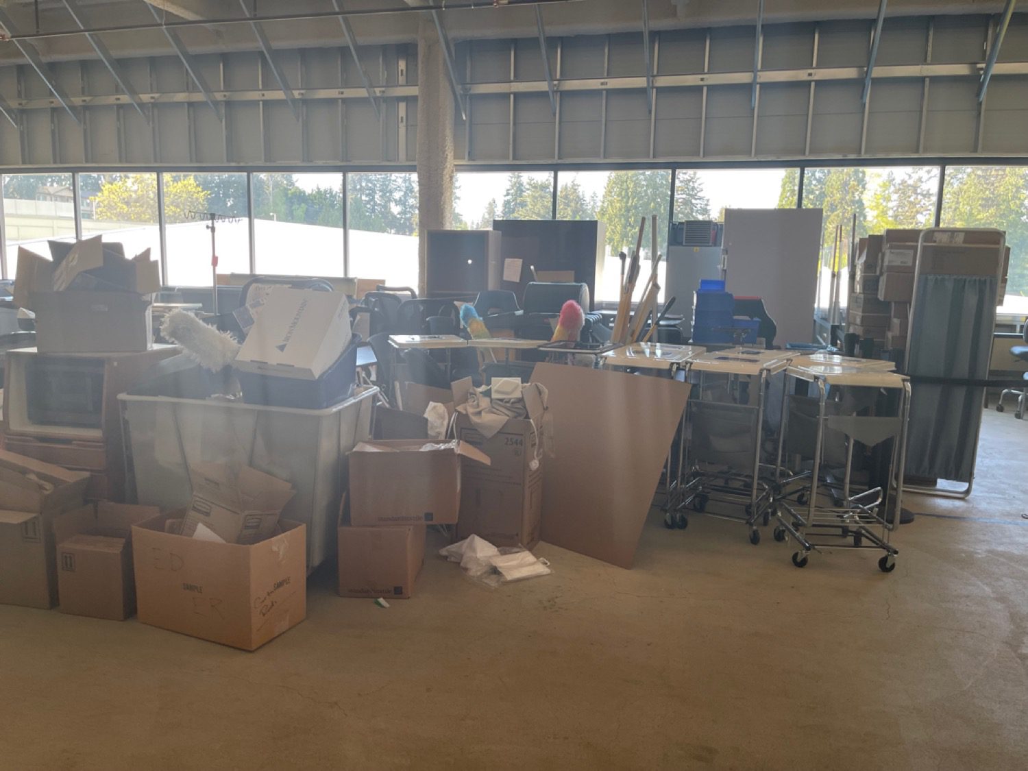 A warehouse storage space packed with boxes and supplies before a Junk B Gone clear-out in Seattle