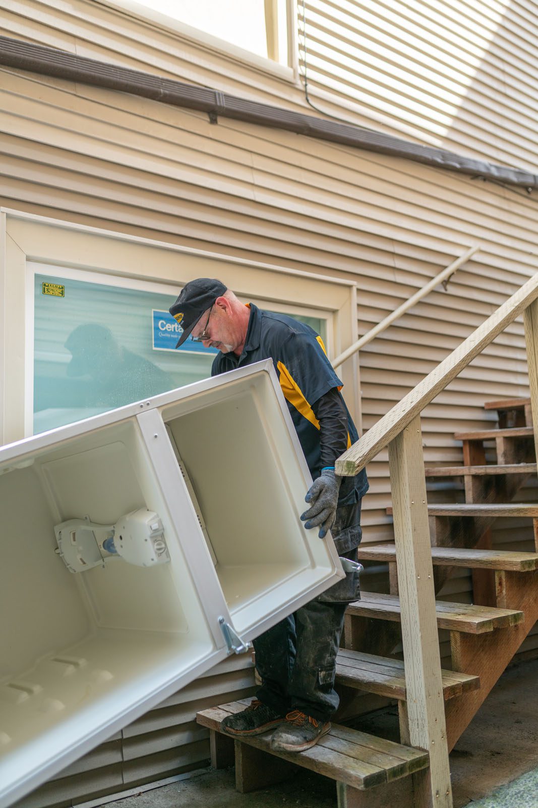 Old refrigerator being removed from Seattle home by Junk B Gone