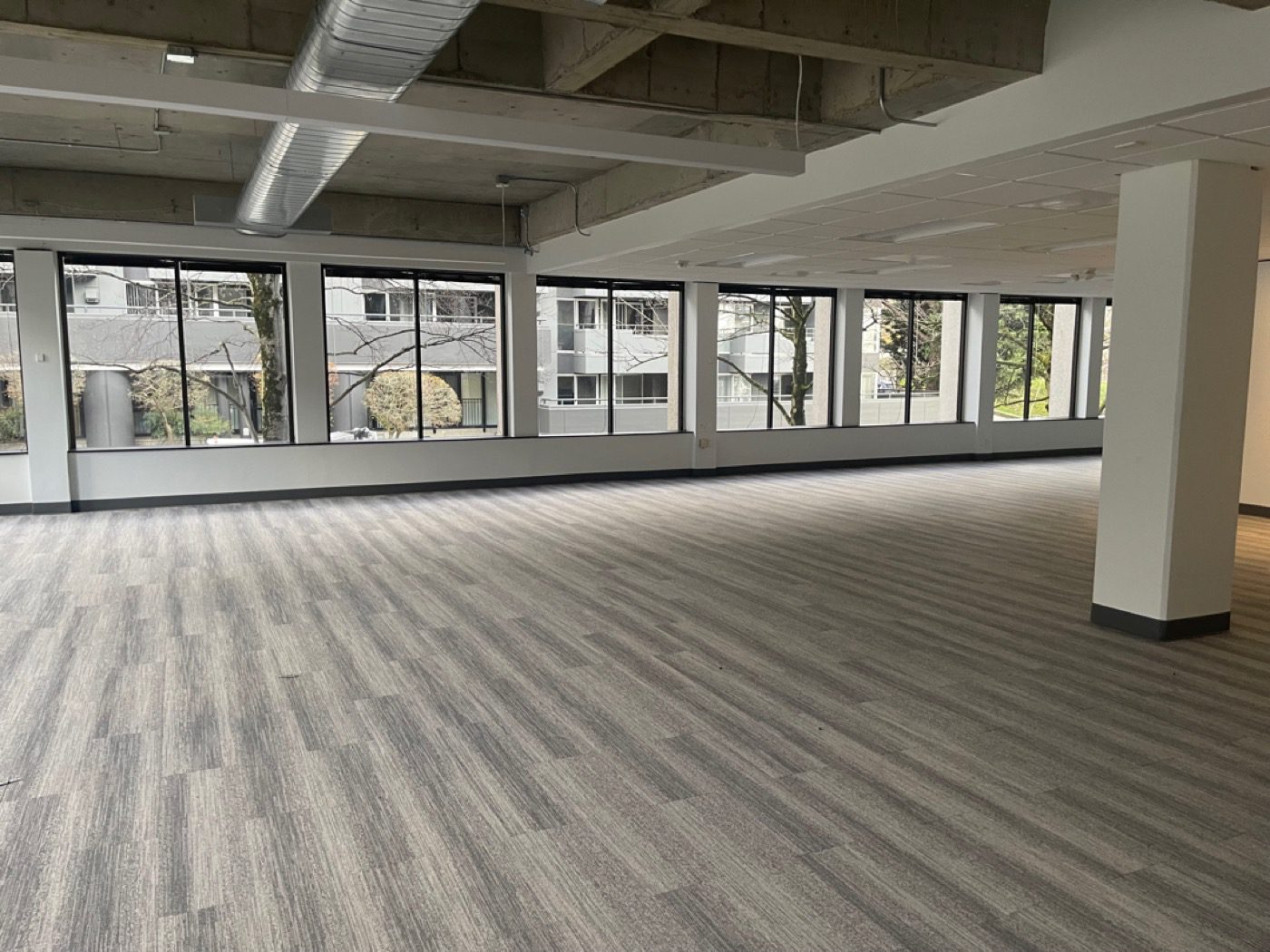 Cleared modern Seattle office with floor-to-ceiling windows after furniture removal by Junk B Gone