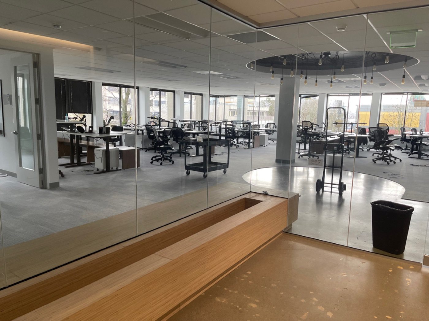 Seattle office floor mid clear-out with desks and chairs by Junk B Gone crew