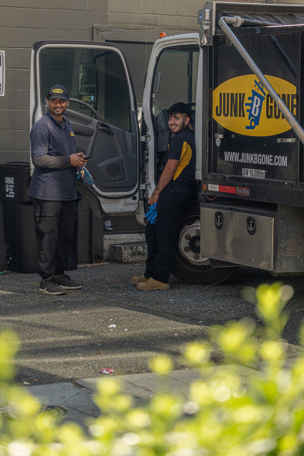 Junk B Gone crew in branded uniforms by truck