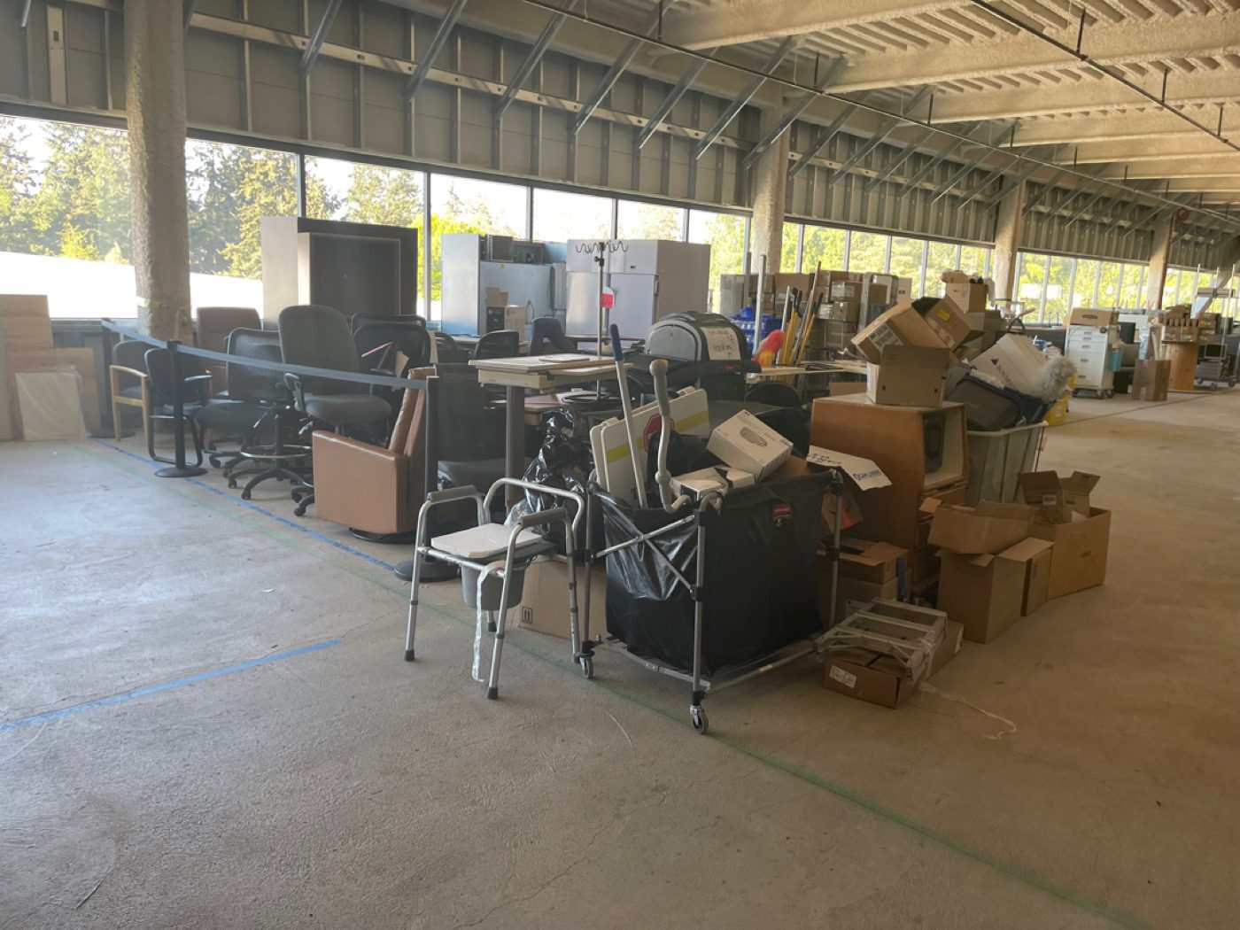 Industrial warehouse bay packed with staged inventory before Junk B Gone cleanout