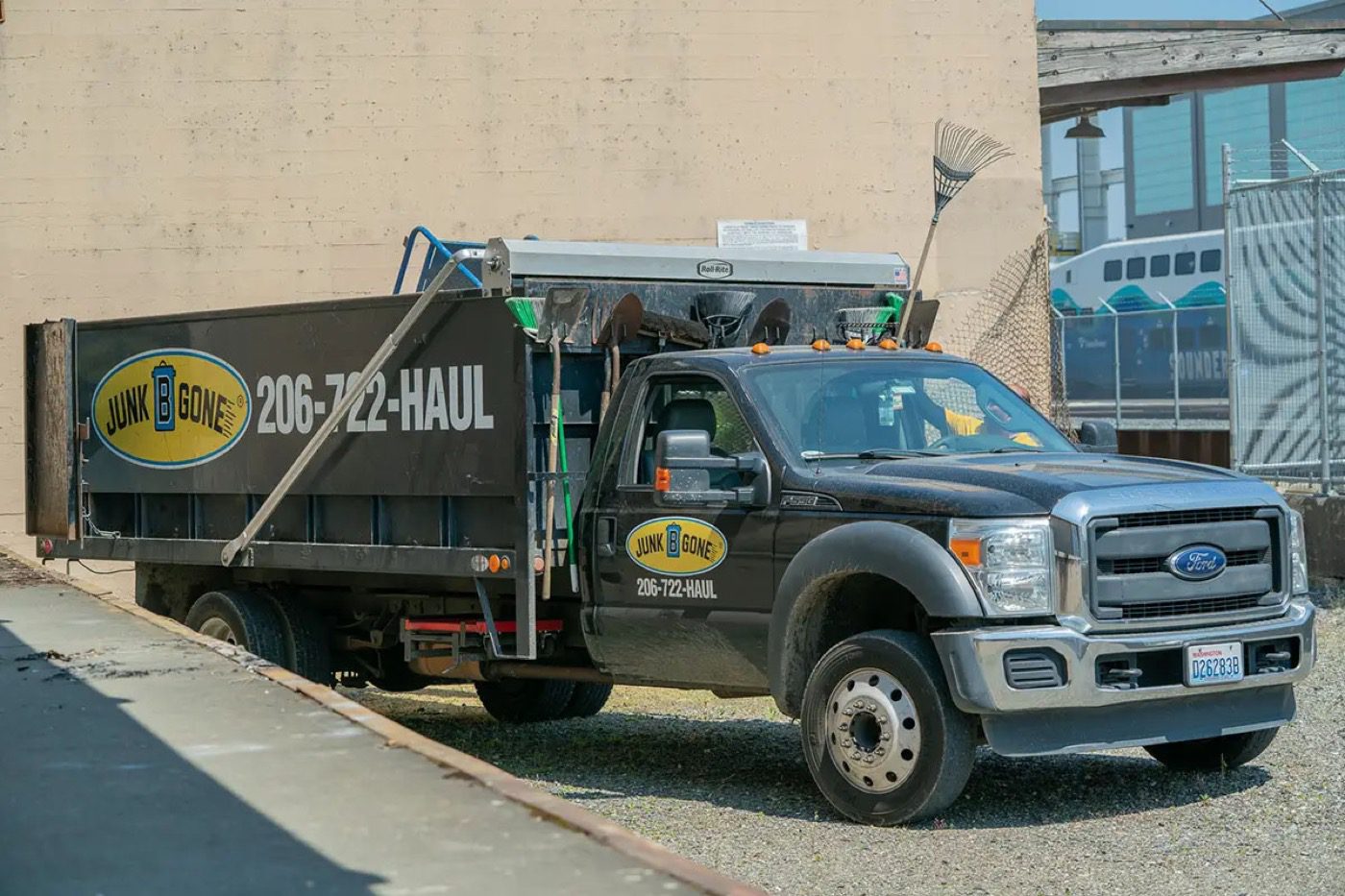 Junk B Gone dump truck parked at a Seattle warehouse for an industrial cleanout