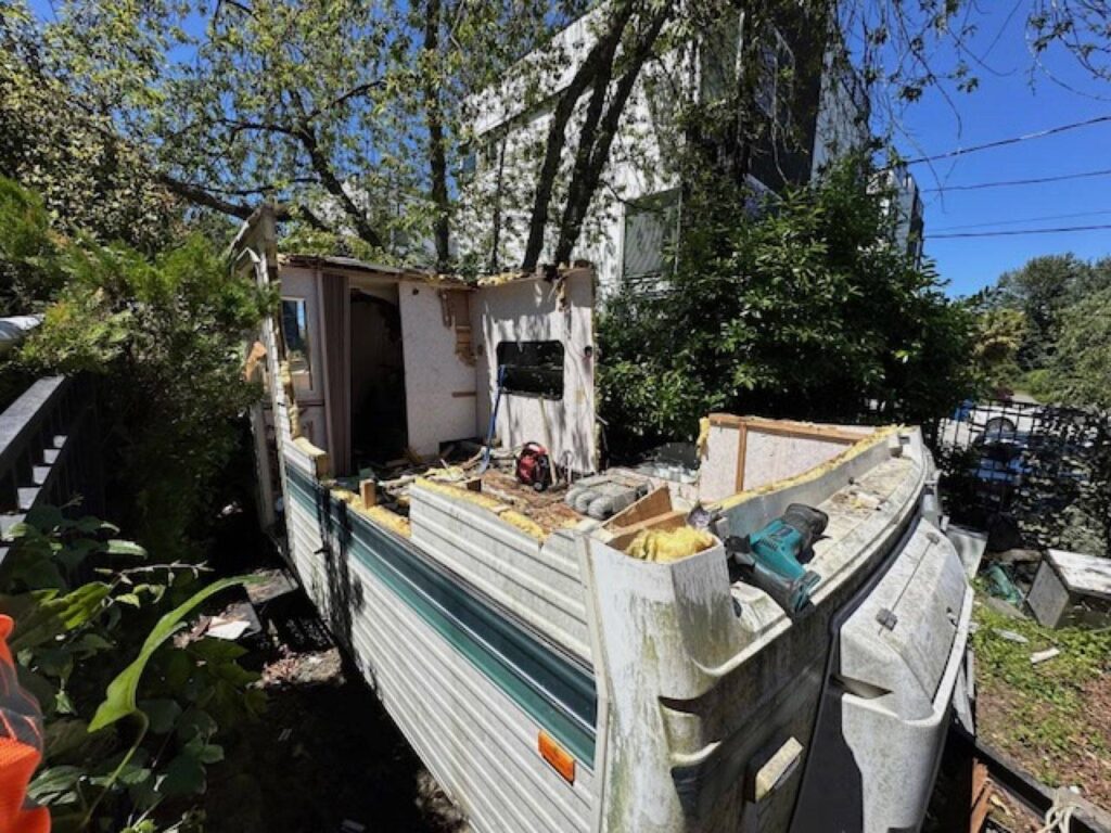 RV stripped down to the floor pan during on-site demolition