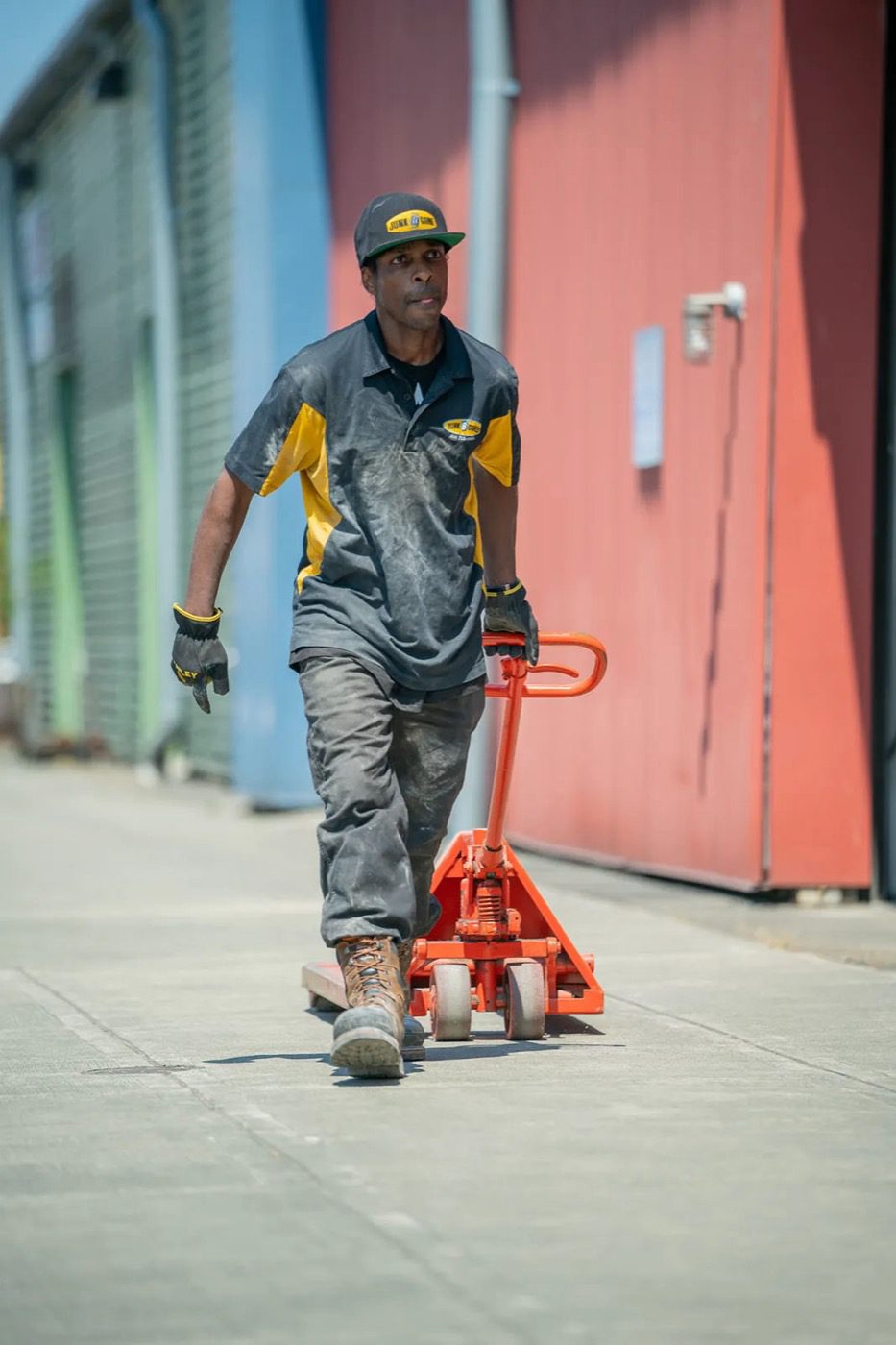 Junk B Gone crew member moving a pallet jack during a Seattle warehouse cleanout