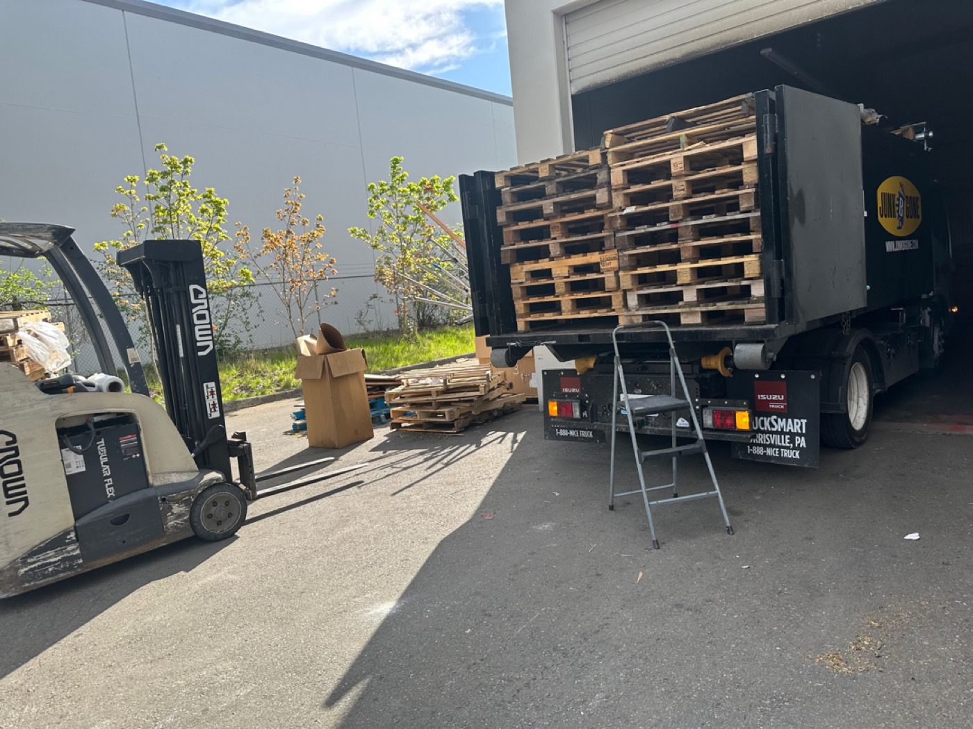 Junk B Gone crew loading pallets at a commercial loading dock in Seattle