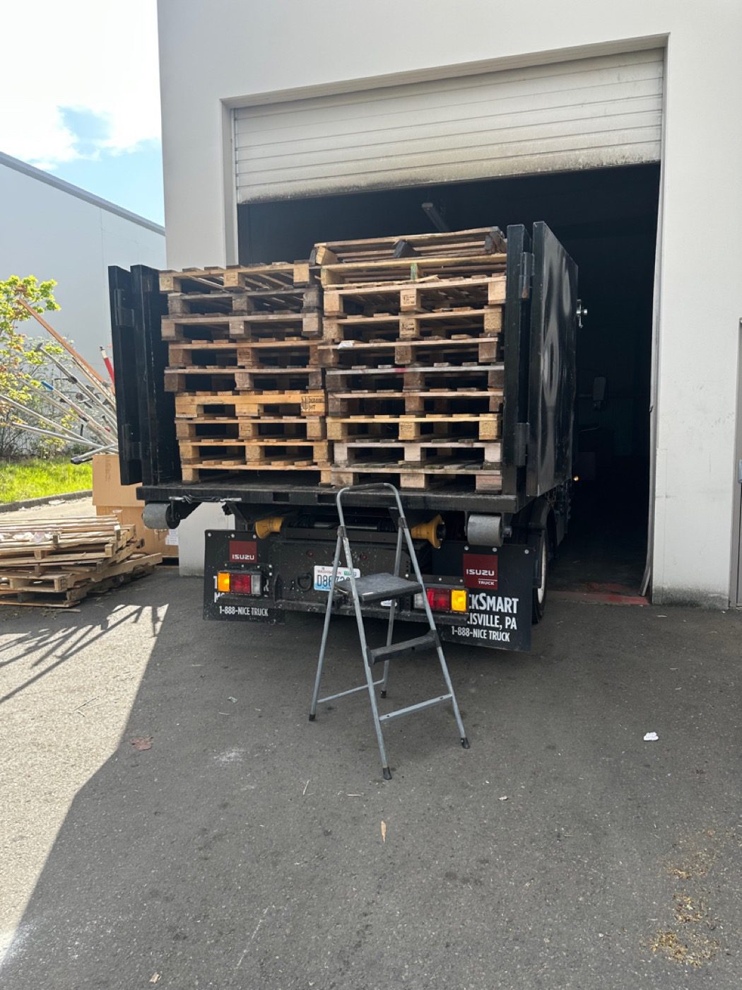 Junk B Gone truck loaded with wooden pallets from a Seattle warehouse