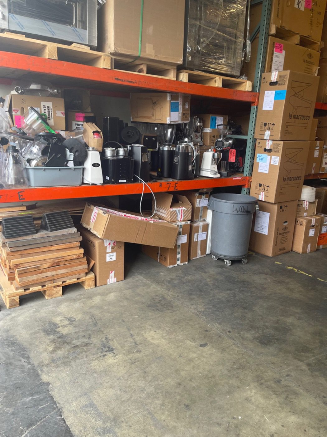 Pallet racking loaded with boxes and equipment before removal in a Seattle warehouse