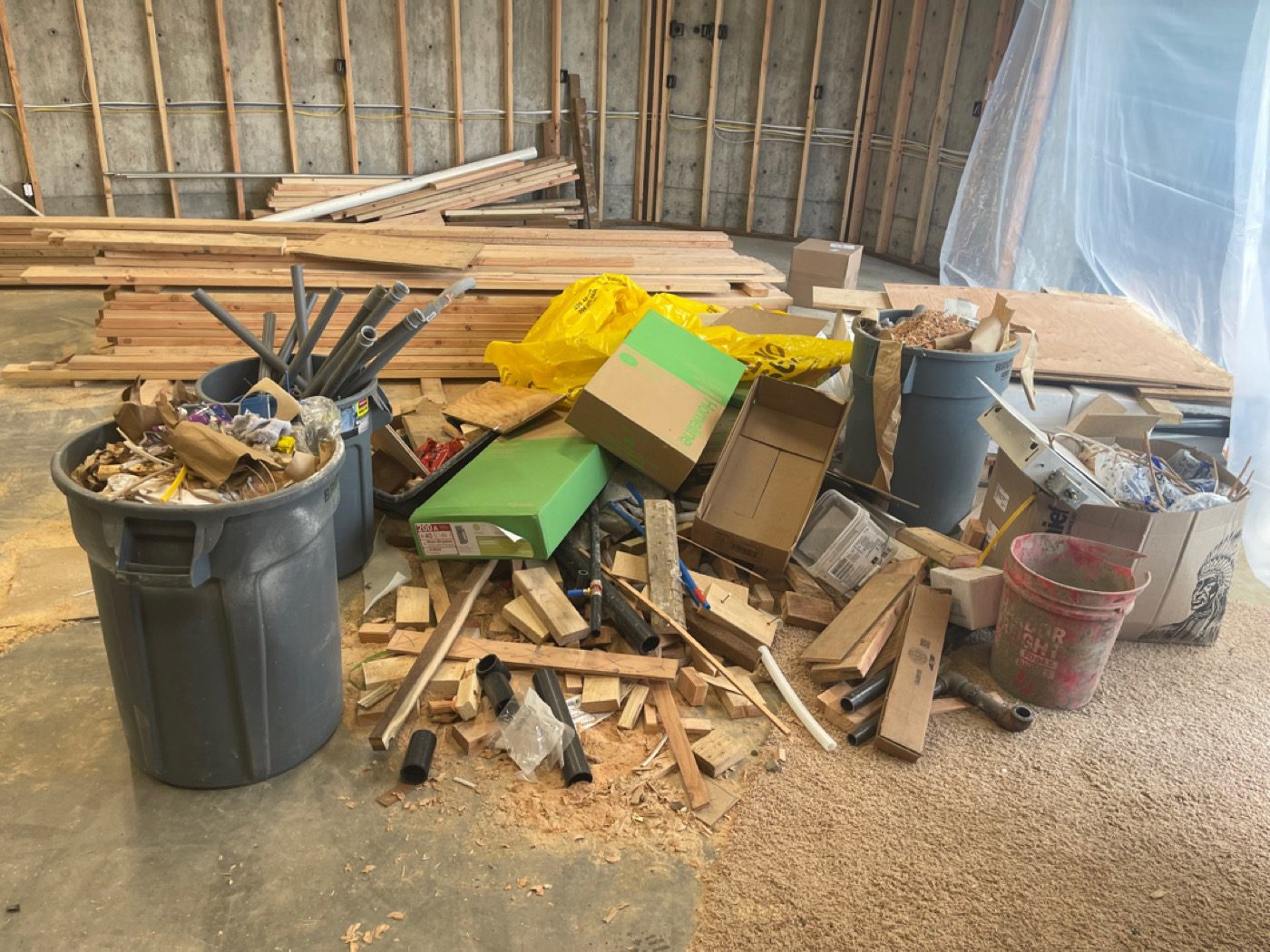 Contractor construction debris staged for haul-off at a Seattle commercial job site by Junk B Gone
