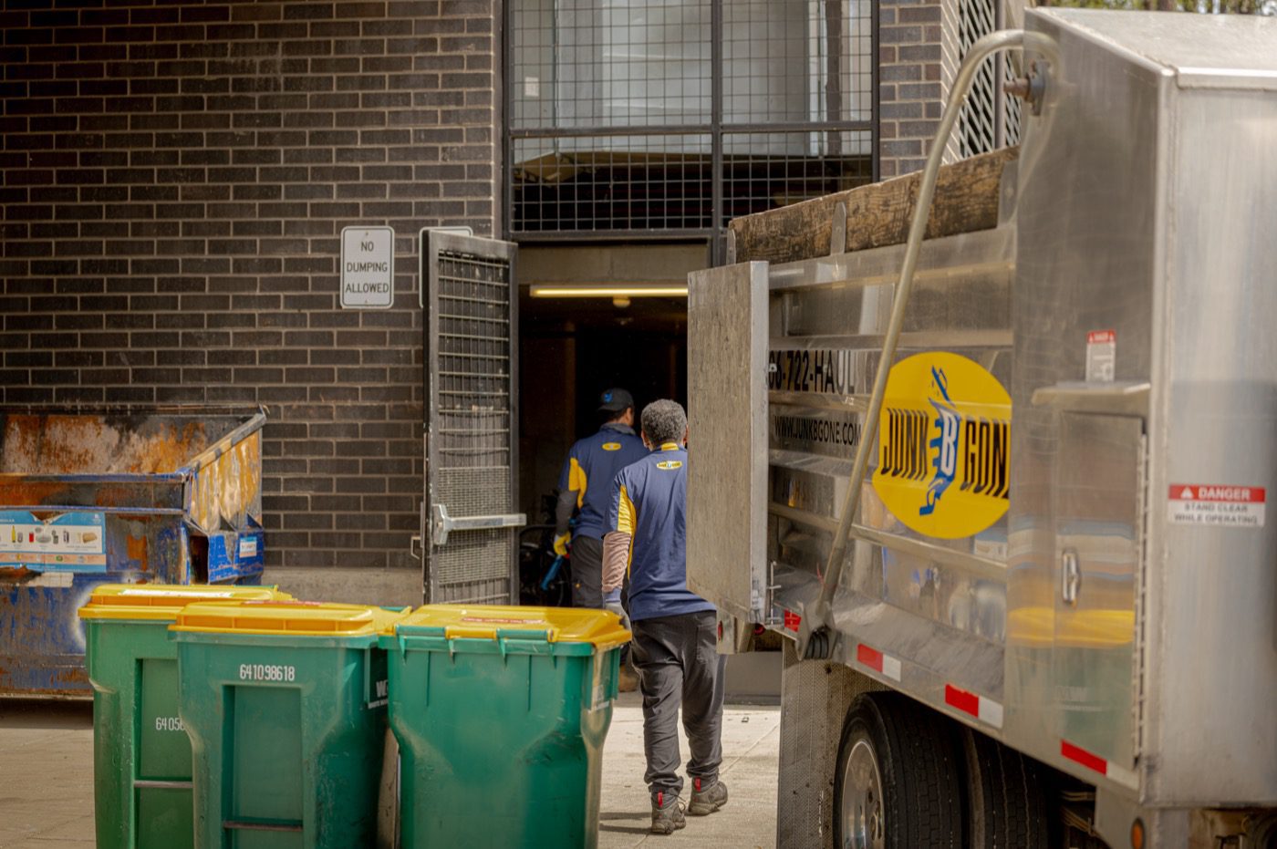 Junk B Gone crew and dump truck at a Seattle commercial loading dock