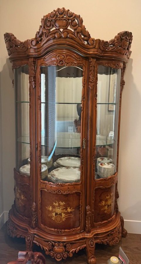 Furniture removal in Seattle - Junk B Gone crew handling an ornate wooden display cabinet with care during an estate cleanout