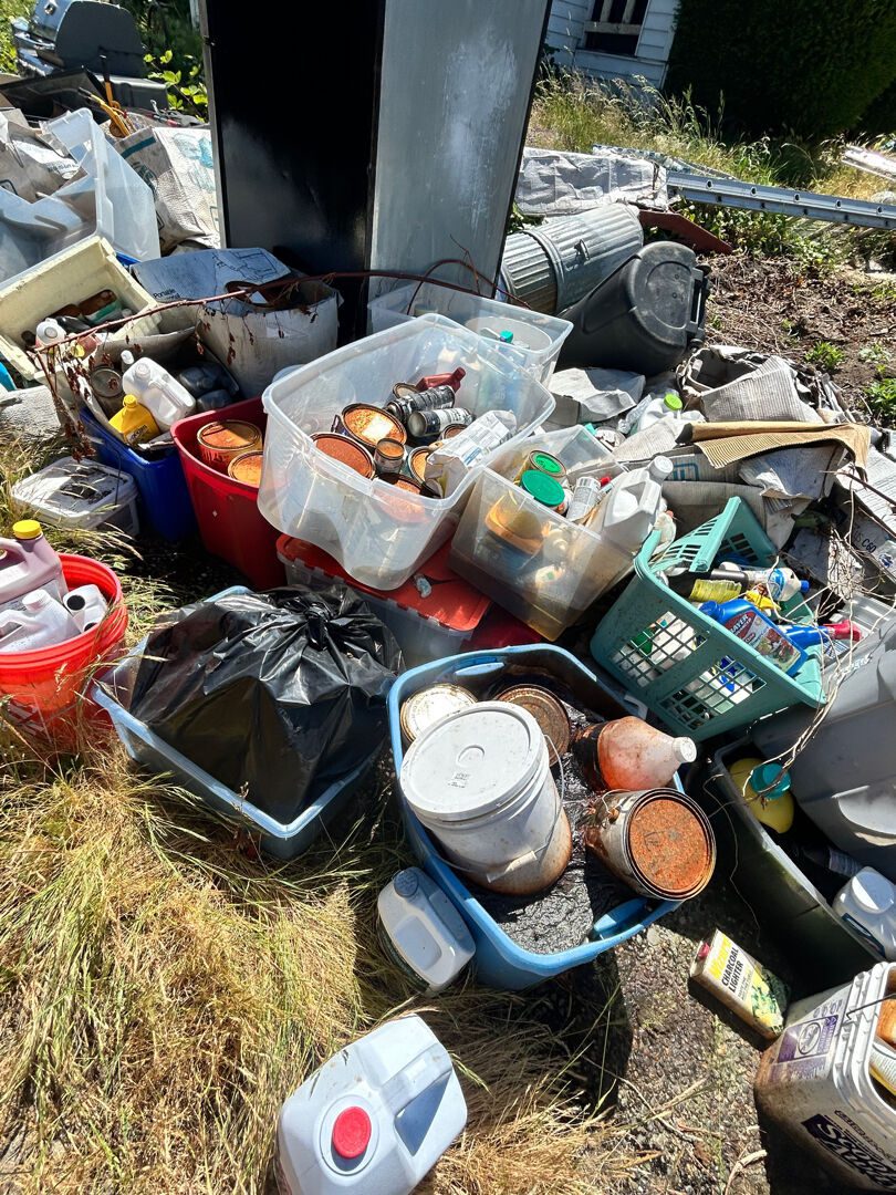 Bins of old paint cans and household chemicals pulled from a Seattle property for responsible disposal by Junk B Gone